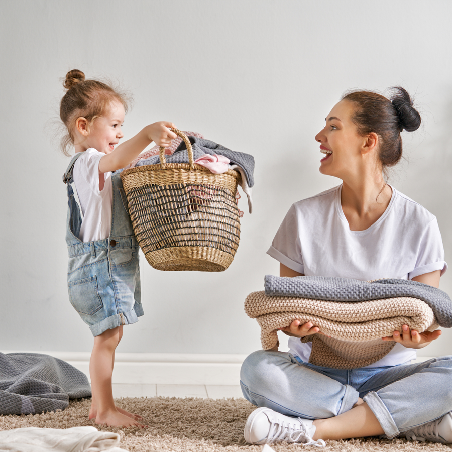 Mãe e filha separando roupas limpas
